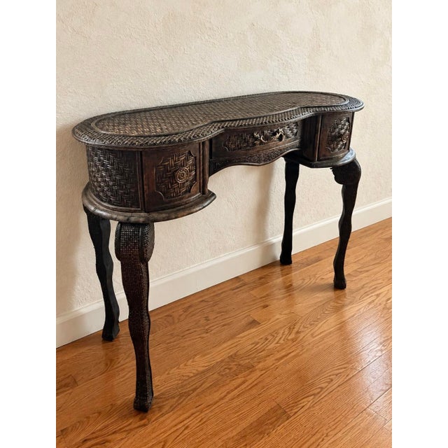 A striking vintage console table that celebrates craftsmanship, texture, and sculptural form. Featuring an elongated,...