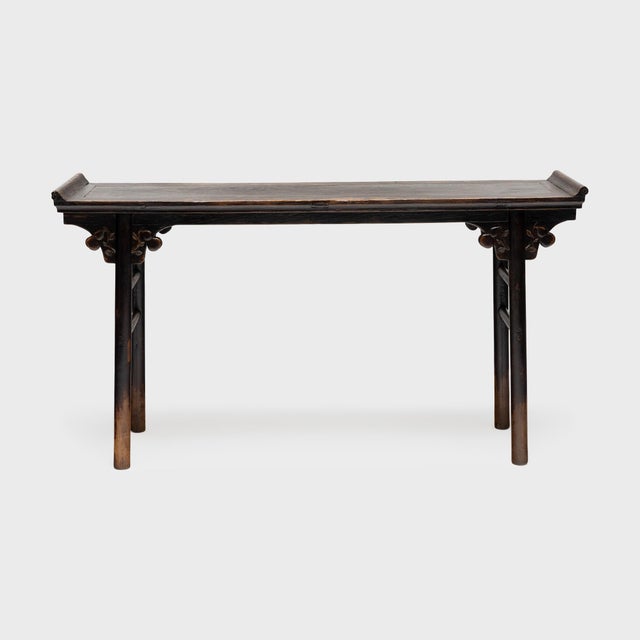 In households throughout China, long tables with everted ends were traditionally placed against the back wall of the main...
