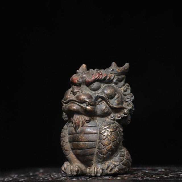 This is a finely detailed antique gilt bronze sculpture of a Qilin, a mythical hooved creature revered in traditional...
