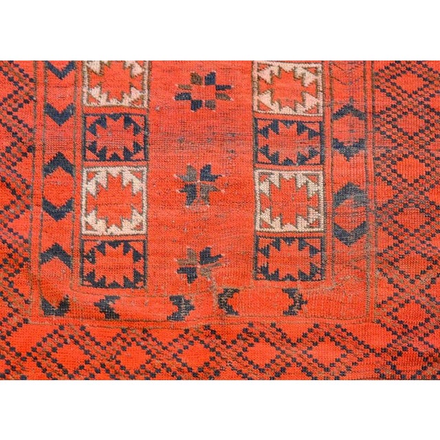 A gorgeous early 20th century Persian Ersari rug with an all-over stylized floral pattered woven in crimson, white, and...