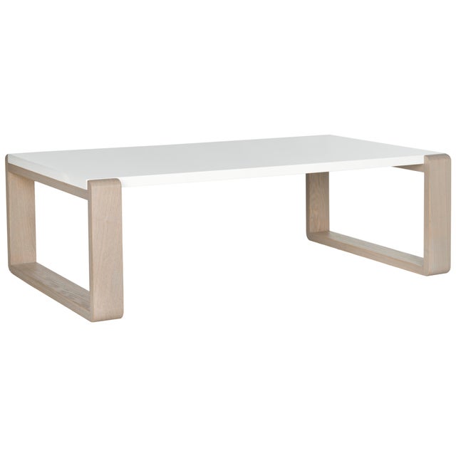 Rugged meets refined in the contemporary coffee table with white lacquer top and chunky wood grained base in a chic grey-...