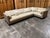 This Holly Hunt sectional sofa features a modern, clean design with beige fabric and matching cushions. Its spacious...