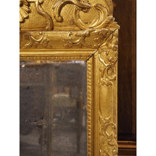 This rare period Regence giltwood mirror dates to circa 1720. Its mirror is original with the often desired loss of...
