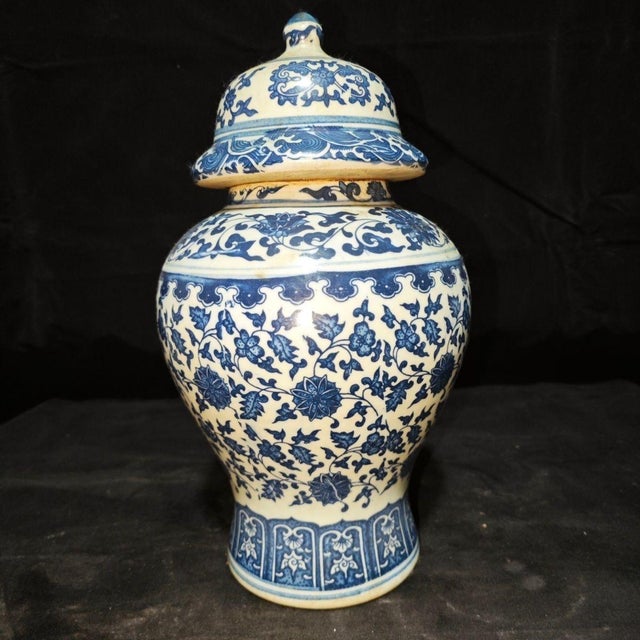 Stately matching pair of Chinese blue and white general’s ginger jars with domed fitted lids and decorative finials. The...