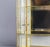 Large Vintage Glass and Brass Curio Display Cabinet This tabletop display cabinet features a brass frame, a mirrored back,...