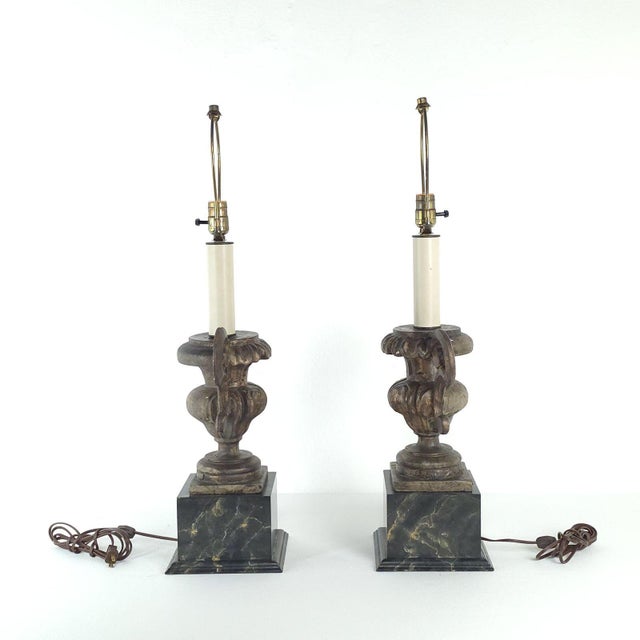 A pair of antique Italian silver gilt and painted urns, now mounted as lamps.