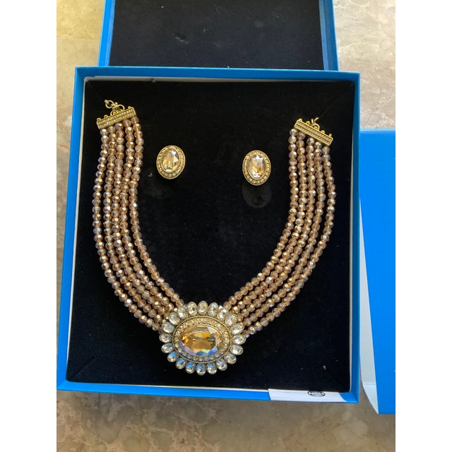 Heidi Daus 5 Strand Amber colored Necklace and earrings set.
