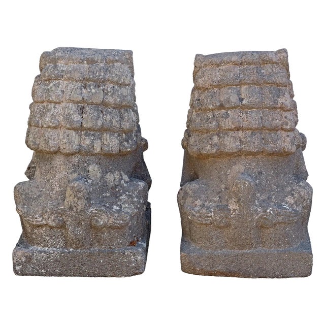 (pair) Chinese cast stone garden foo lions/ dogs, both with single paw raised and resting on ball, rising on plinth base,...