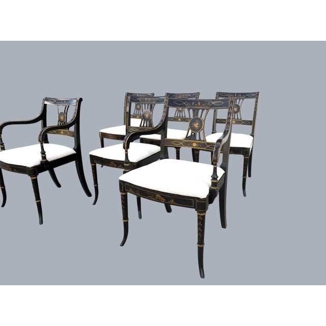 A very attractive set of 6 Chinoiserie Dining Chairs in the Regency Style. Two Captain's chairs and 4 side chairs. An...