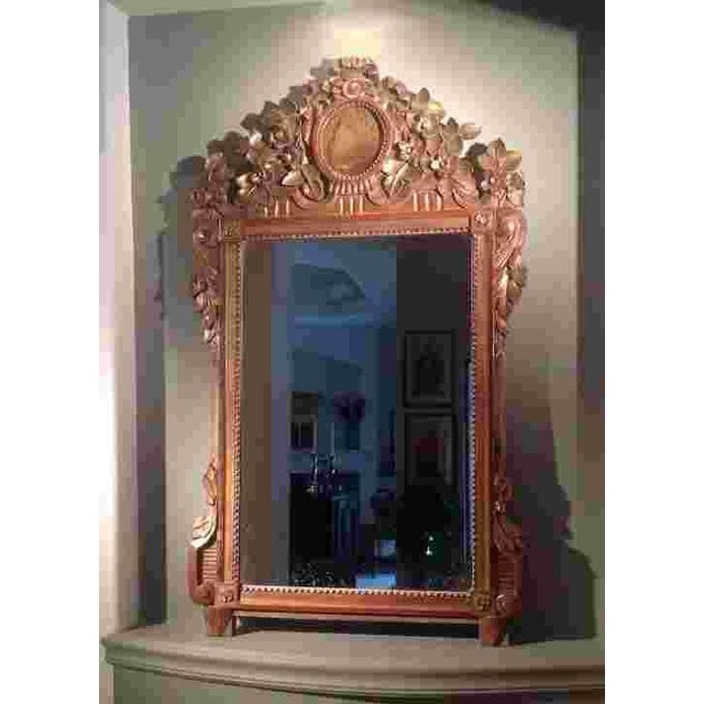 A fine 18th century carved giltwood c. 1770 Italian mirror, in the baroque fashion, still retaining much of its original...