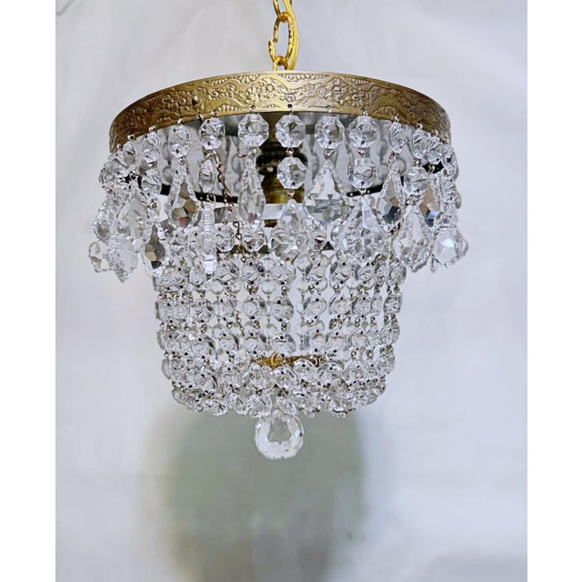 Add a touch of timeless, romantic glamour to your space with this exquisite vintage mid-century tiered brass crystal...