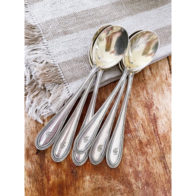 A set of 6 antique silver plated small round bowl soup spoons made by Tiffany & Co in the 1903 Norman pattern. In...