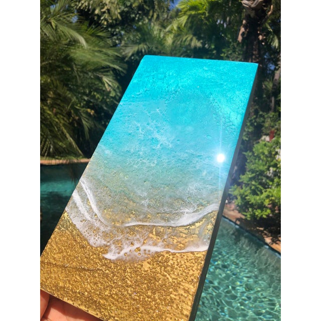 Teal Waves #50 presents a serene depiction of oceanic beauty, where vibrant teal hues blend seamlessly with sandy tones to...