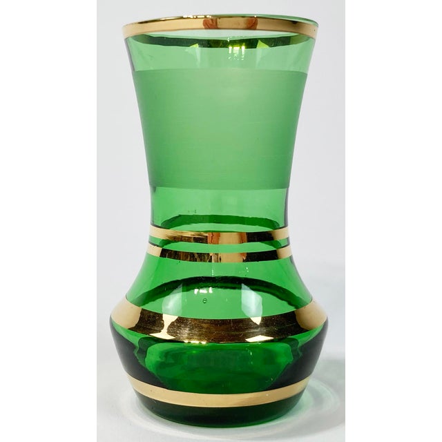 Vintage French petite bud vase of green glass rimmed in a gold overlay with gold stripes throughout. Wonderful for a tiny...