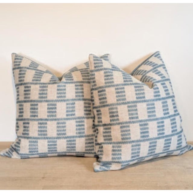 Fermoie Cover Pillows in Blue feature geometric waves in shades of medium blue on a neutral heavyweight linen. Invisible...