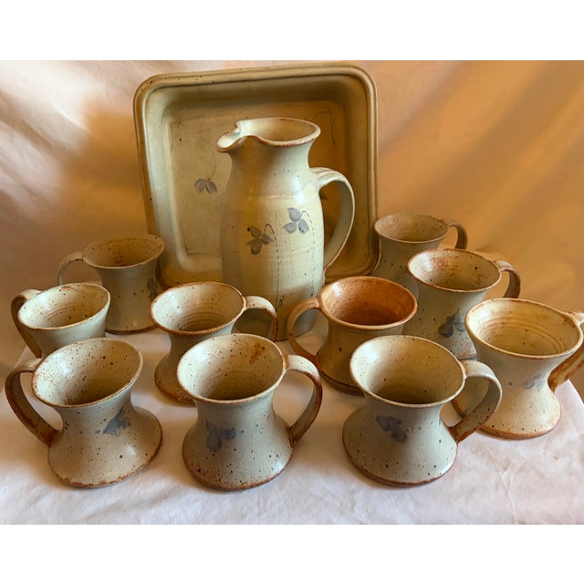 This handcrafted pottery pitcher & cup set, with a tray is unique and charming addition to any kitchen. Made of ceramic in...