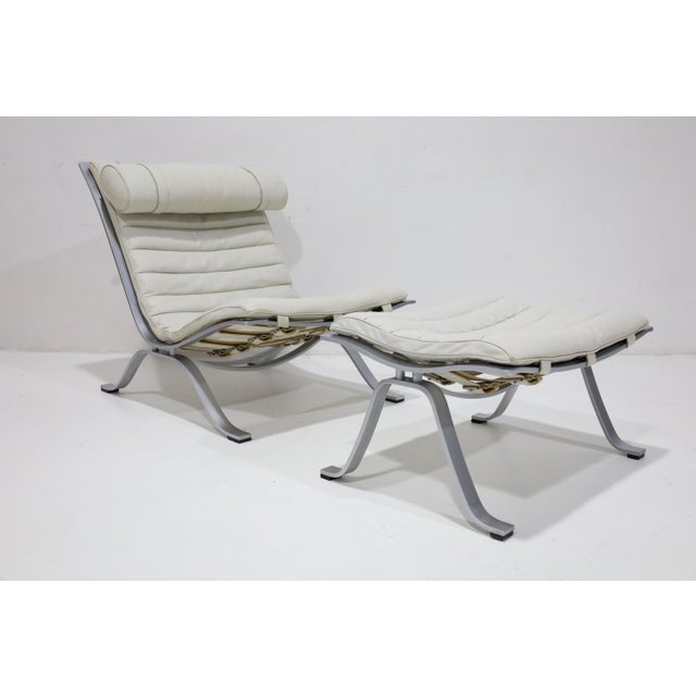 This rare easy chair with matching stool, model Ari, designed by Arne Norell and produced by Arne Norell AB in Aneby,...
