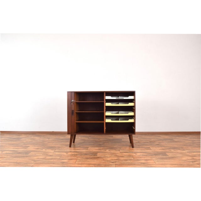 This teak sideboard was made in the 1960s in Denmark. The sideboard has a characteristic tambour door with beautifully...