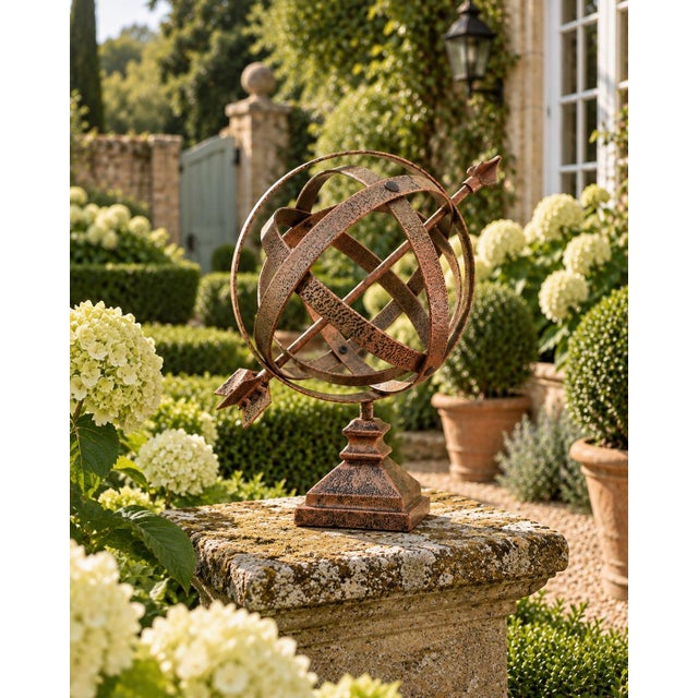 A beautifully crafted hammered copper armillary sphere, evoking the timeless elegance of classical European gardens....