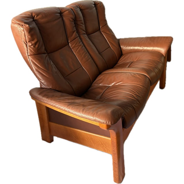 Comfortable Scandinavian-style vintage Ekornes stressless reclining loveseat made in Norway from the 1980s. The leather is...