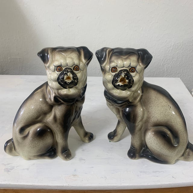 This delightful vintage pair of seated Pug figurines features wonderfully expressive faces, sculptural forms, and a...