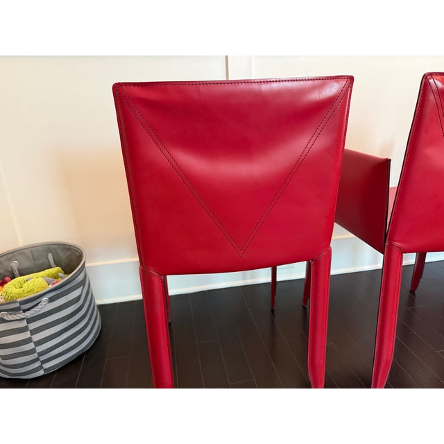 Cattelan Italia dining chairs in red. 2 with, 2 without arms. Padded seat. Selling after living out the bachelor pad age...