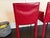 Cattelan Italia dining chairs in red. 2 with, 2 without arms. Padded seat. Selling after living out the bachelor pad age...