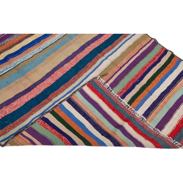 Beautiful vintage Turkish Kilim hand-knotted wool rug with a blue field. This piece has multicolor accents in an all-over...