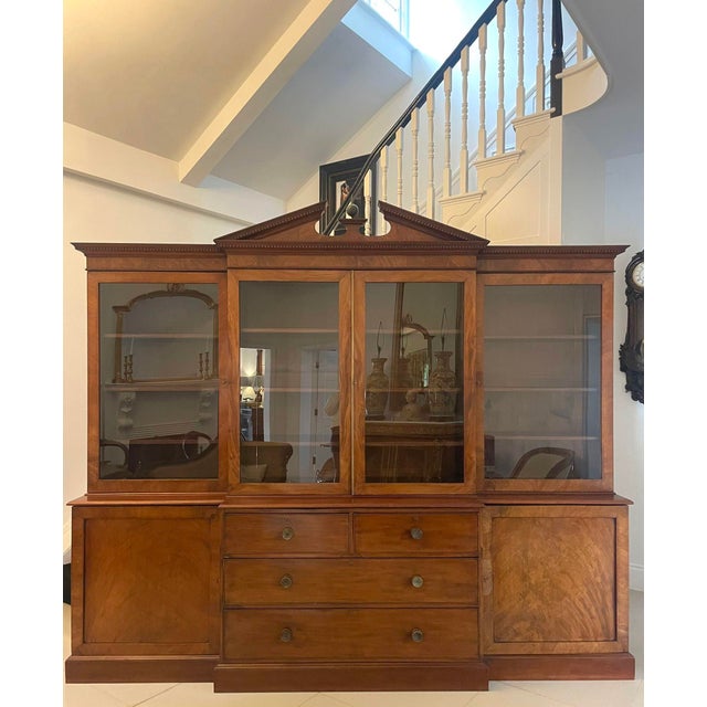 Large Antique George III quality mahogany breakfront bookcase having a swan neck pediment above a dental moulded cornice...