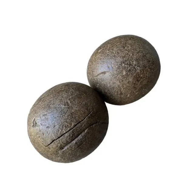 A pair of antique European wood bowling balls from Romania, mid-19th century — primitive, with knicks and a surface crack....