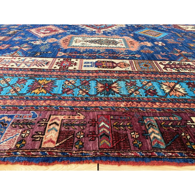 This vintage rug is hand-knotted in fine kork wool, woven in Afghanistan in the Shirvan Caucasian tribal design tradition....