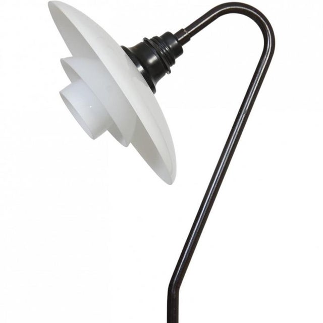 Poul henningsen ph3/2 vintergækken floor lamp with a frame of black painted brass and opal glass shades. The lamp is from...