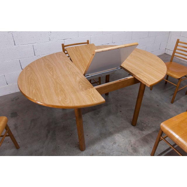 Modernist Danish-made dining set comprising a round convertible table and four matching chairs from the 1980s. This set is...