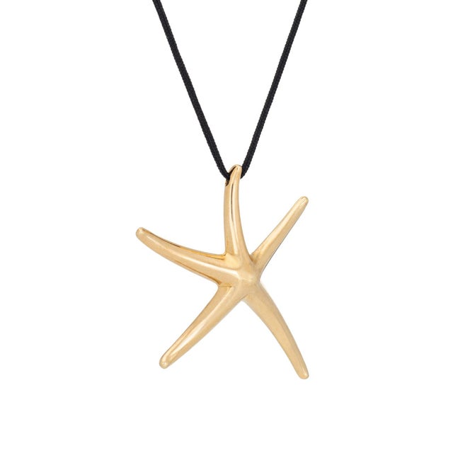 Stylish and finely detailed pre-owned Tiffany & Co starfish pendant on a black silk cord necklace, crafted in 18k yellow...