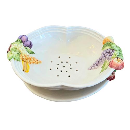 A beautifully crafted ceramic majolica fruit dish and drainer set, featuring vibrant hand-painted relief fruit motifs....