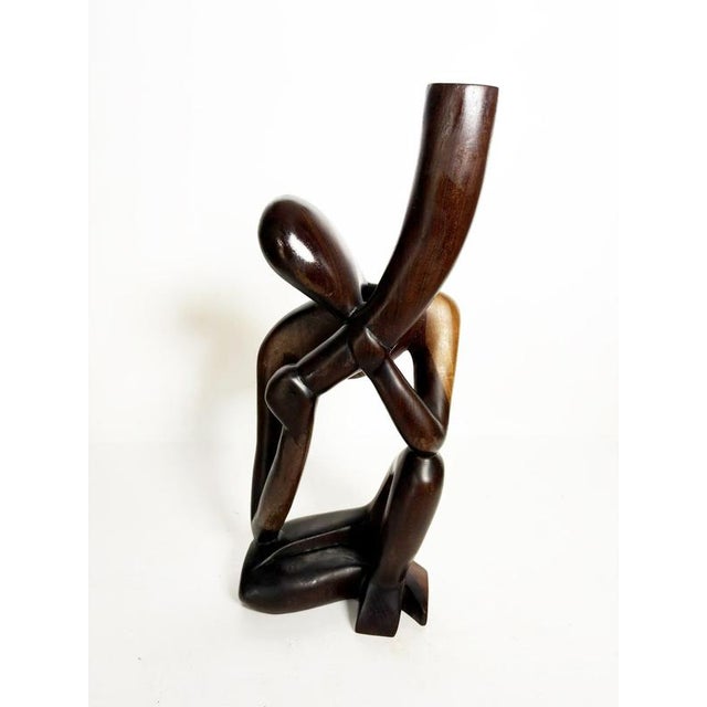 Wooden sculpture depicting a stylized female bust, created in France around the 1980s. The work is distinguished by its...