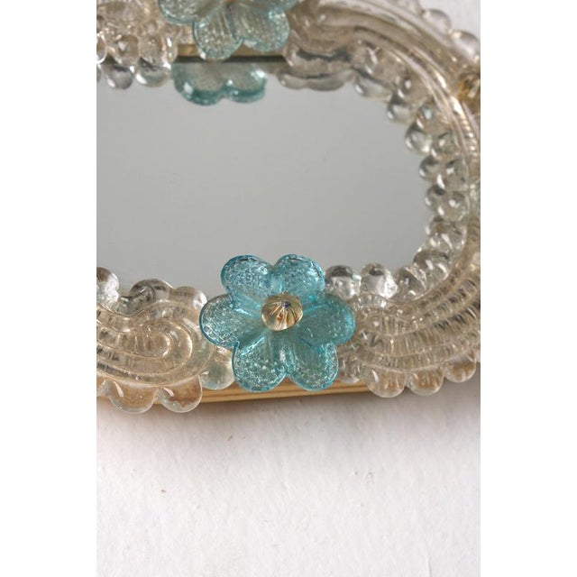 This small vintage Venetian Murano glass wall mirror is a charming example of traditional Italian craftsmanship. Crafted...