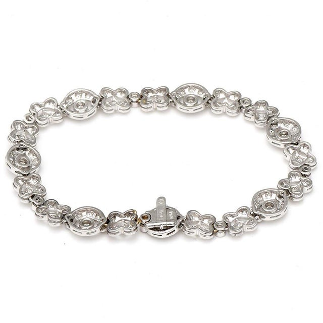 Platinum and diamonds join together to create an exceptionally timeless and memorable link bracelet. The shapes are...