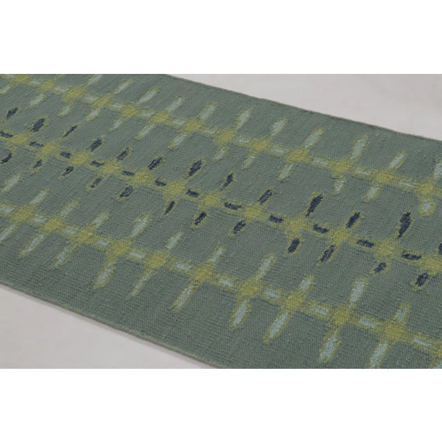 Handwoven in wool and undyed natural yarns, this 3x6 runner and flatweave is a premier selection from our contemporary...