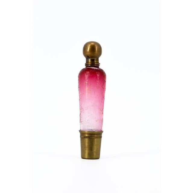 An elegant cylindrical perfume bottle (or salt bottle), crafted from multilayered art glass with refined gold decorations...