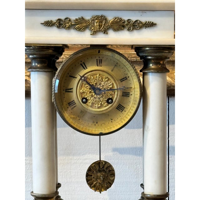A stately French Empire mantle clock. In marble with bronze mounts Chairish sells electronic items only with the display...