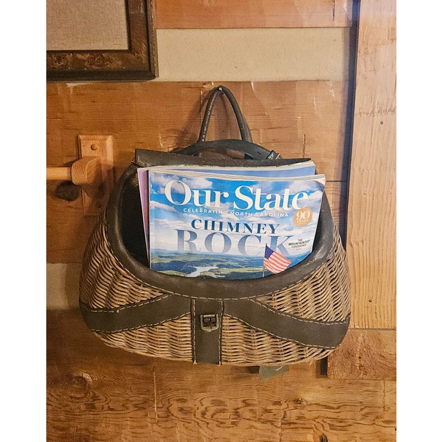 This vintage wicker fishing creel was once a trusty companion for anglers, used to carry and keep their catch fresh....