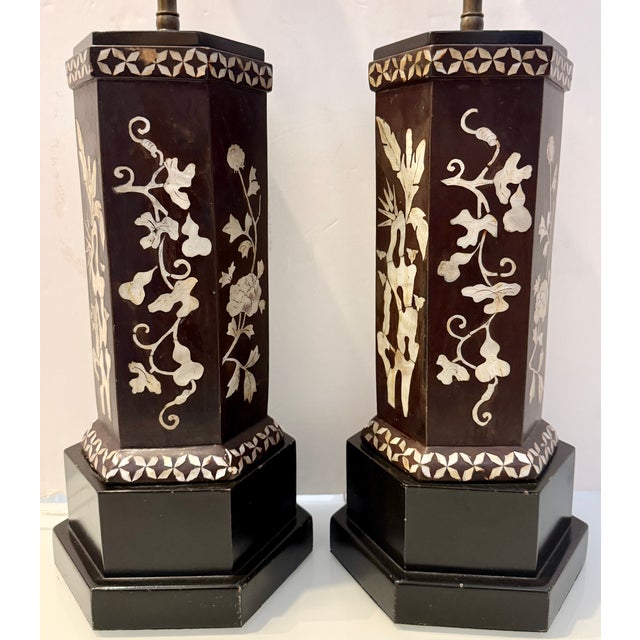 Pair of Chinese Cong-style hexagonal table lamps from 60's. They feature a black lacquered wooden body with intricate...