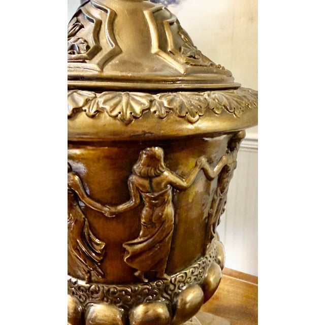 This urn serves primarily as a decorative accent for interiors, enhancing a traditional or classical aesthetic. The urn’s...