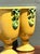 Exemplifying the cheerful elegance of mid-century Italian ceramics, this pair of pedestal vases features a radiant golden-...