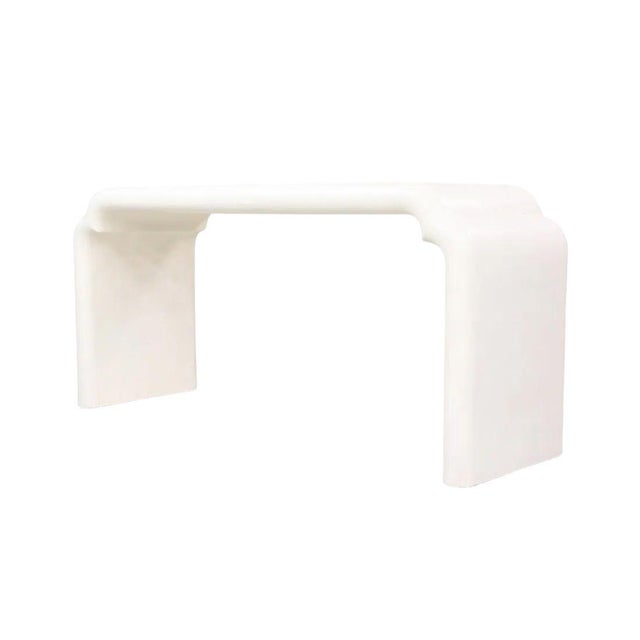 This Karl Springer style white waterfall console table features a sleek, sculptural silhouette with smooth rounded edges...