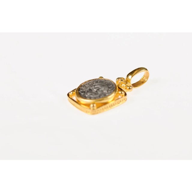 An authentic Greek Apollonia Pontika, AR Drachm Coin (Thrace, circa 450-400 BC), set in a squared 22k gold bezel and bail....