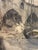 A beautifully detailed vintage etching depicting a bustling Old World harbor scene, with figures moving along the...