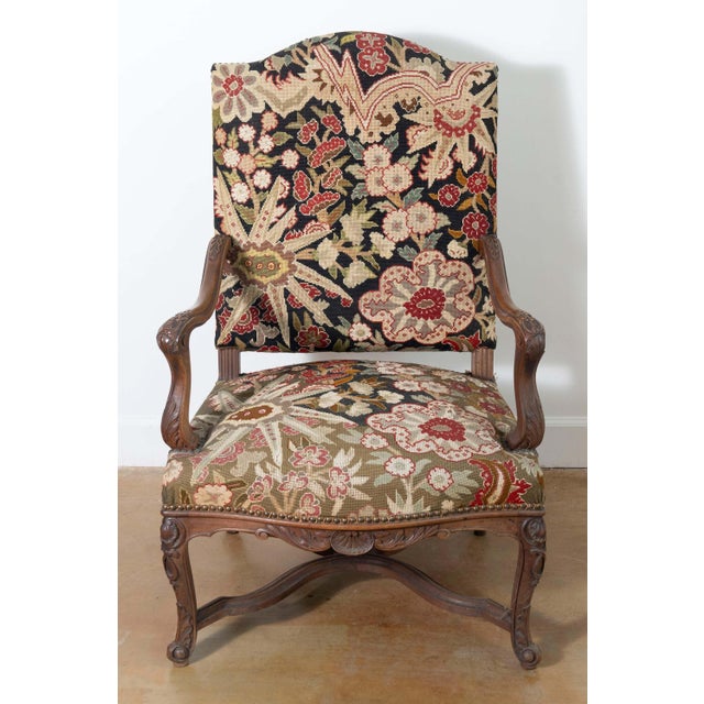 This 19th-century French armchair exemplifies refined craftsmanship and timeless design, showcasing the elegance of Louis...