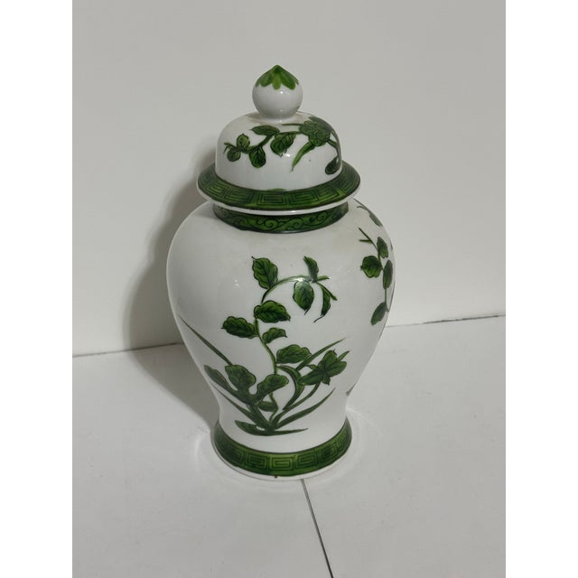 This is a vintage Andrea by Sadek porcelain lidded ginger jar in the Chinoiserie style featuring a hand-painted green...